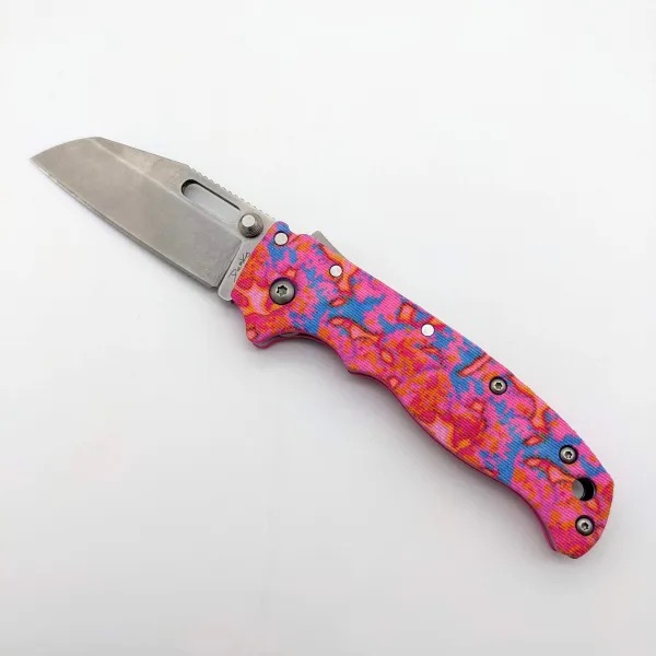 A folding knife with a one-of-a-kind pink and blue printed handle